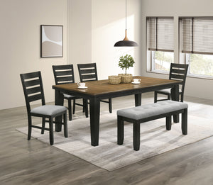 This dining group effortlessly combines farmhouse warmth with modern sophistication, creating a captivating focal point for any dining space. The table features a rich, two-tone design with a beautifully finished wood top and contrasting dark legs, delive