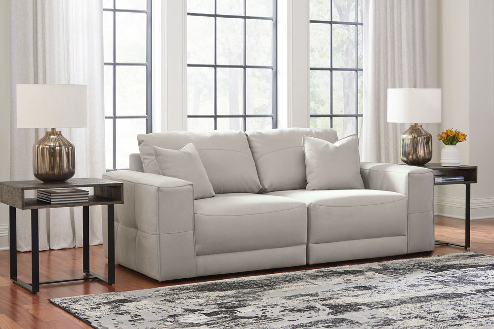 The expansive silhouette of this sectional loveseat invites you to spread out and relax. Upholstered in a durable gray faux leather that captures the look and feel of nubuck leather, this stunning piece envelops you in baby-soft comfort. Its clean modern 