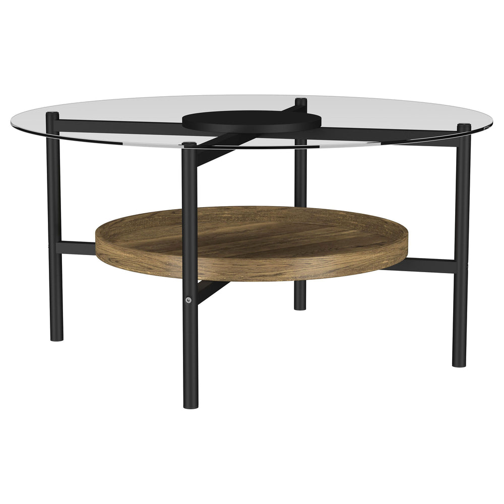Center your living space with this inviting transitional coffee table that combines farmhouse charm with modern elegance. The X-cross frame is exposed beneath the round tempered glass top, adding dimension and visual interest. A black finish disc at the i