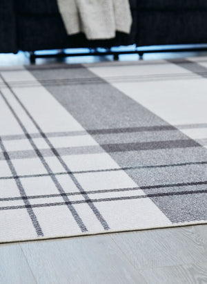  with shades of gray crisscrossing against a solid cream background