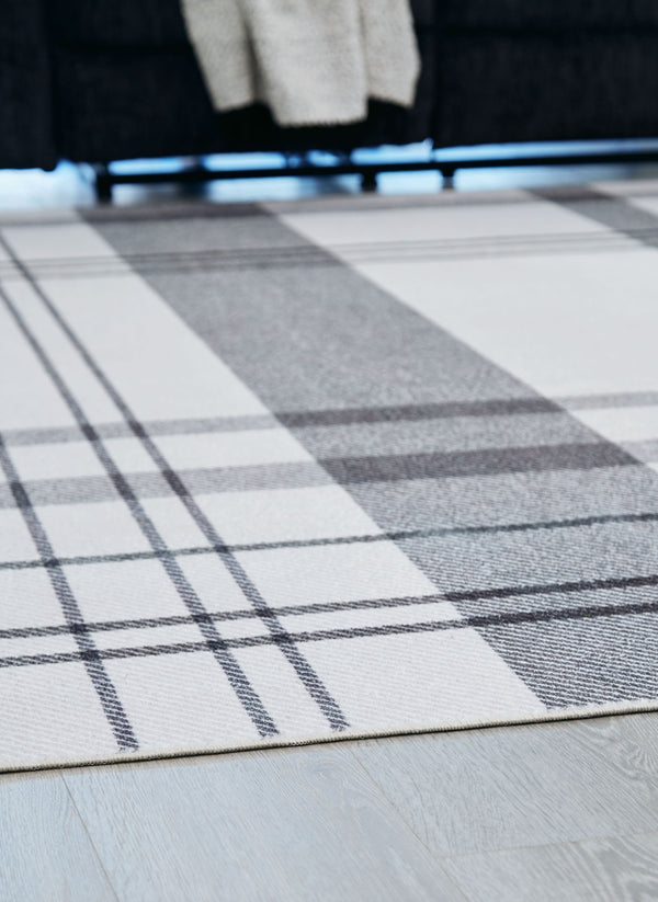  with shades of gray crisscrossing against a solid cream background