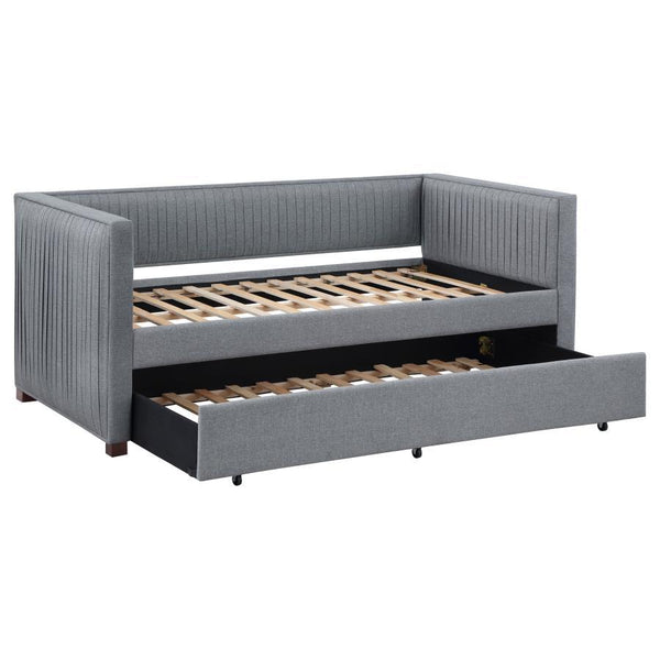 A gray fabric, pleated and overlapping along the surface of this twin daybed and trundle set, create a textured appearance against the clean straight lines. The narrow arms and backrest invite you to get creative with your own accent pillows and throws, o