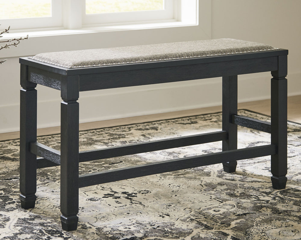 Invite your family into the heart of your home with this upholstered dining room bench. Its tapered legs provide a sturdy foundation, while the counter height design raises the bar on fine dining. With a textured black finish and heavy woven upholstery ac