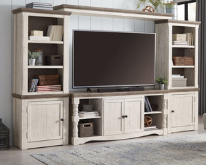 Casual farmhouse design. Made with Pine solids and veneer with engineered wood substrate. Two-tone finish scheme with distressed weathered gray tops and trim set on distressed vintage white case. The 67â€ wide TV stand features open shelving on the ends 