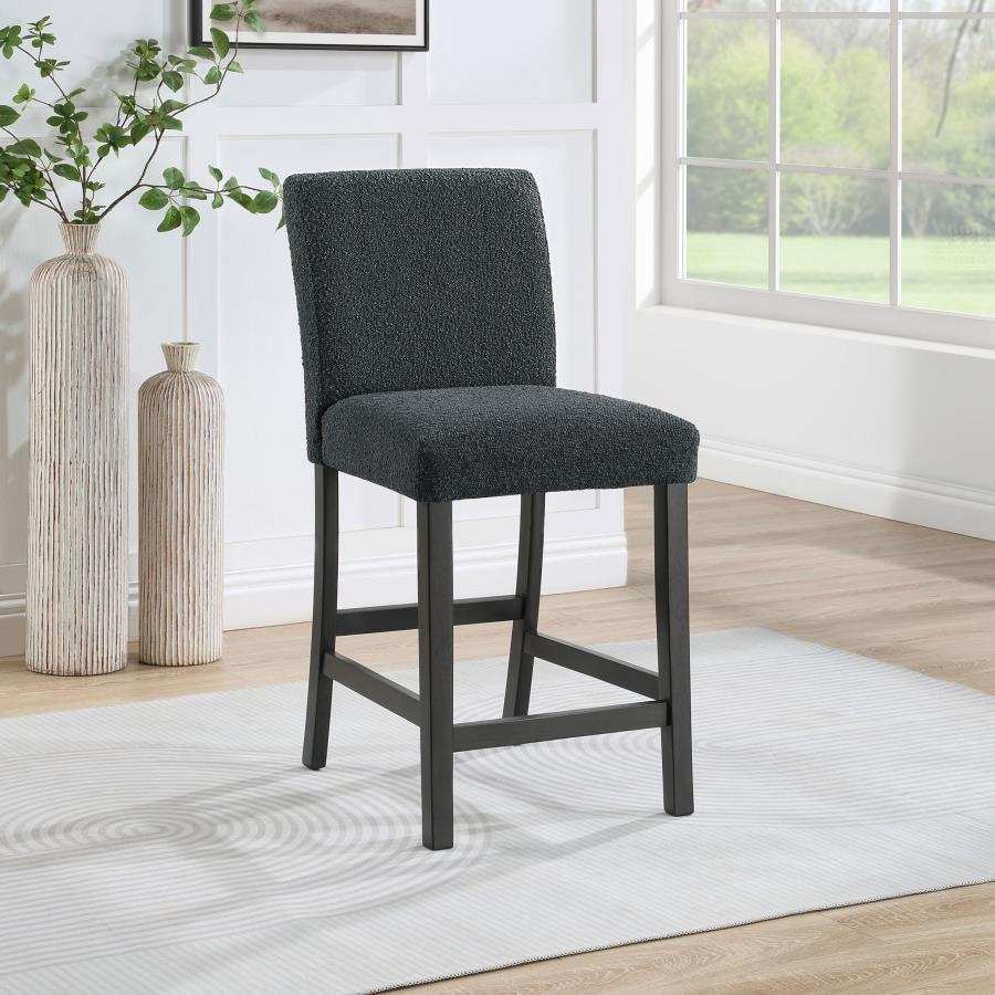 Elevate your dining experience with this chic counter height chair, a blend of simplicity and texture. Wrapped in the luxurious touch of boucle fabric, the chair offers a tactile feast, inviting guests to savor every second seated. Its silhouette stands t