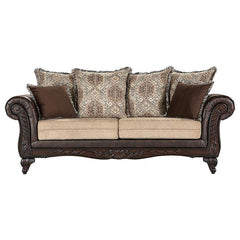 Plush indulgence meets traditional design in a compelling upholstered sofa. Its regal stance showcases dramatic rolled arms, complete with carved enhancements across their fronts and the sofa-'s apron. The carvings continue on curvy feet, while dark brown