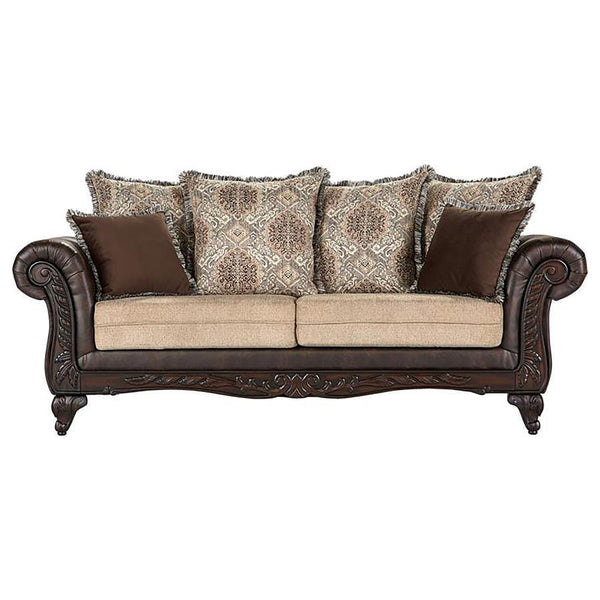 Plush indulgence meets traditional design in a compelling upholstered sofa. Its regal stance showcases dramatic rolled arms, complete with carved enhancements across their fronts and the sofa-'s apron. The carvings continue on curvy feet, while dark brown