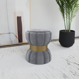  with a wide band highlighting in a bright gold finish. The round ottoman is a compact addition