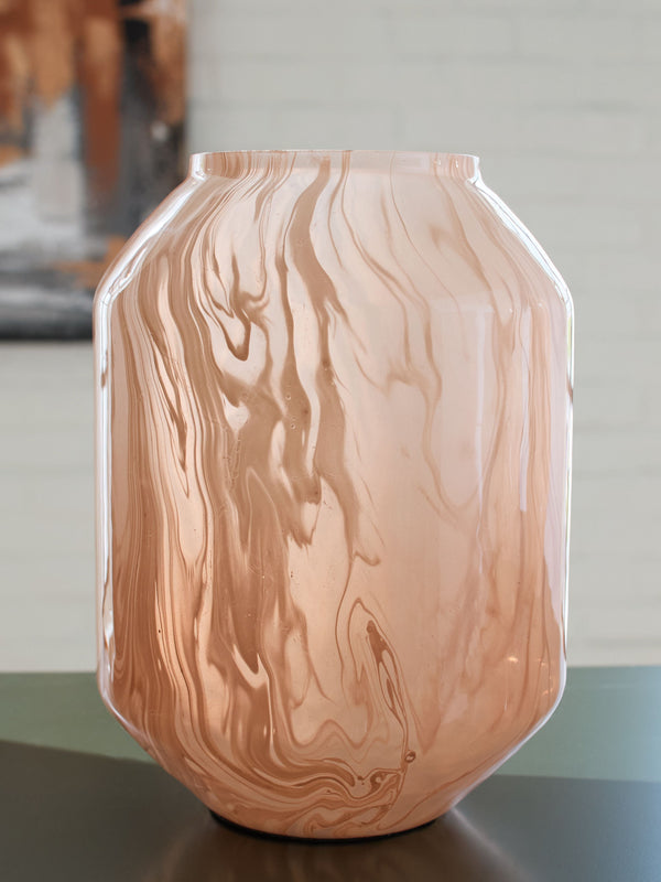  this vase has a chic sensibility that elevates your decor. Its contemporary silhouette is topped in a blush pink finish and flowing swirls
