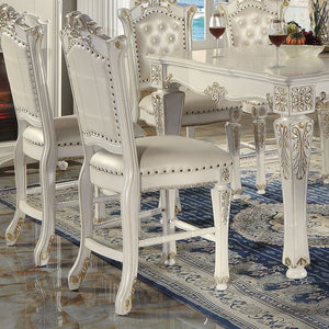  Armless Chair Padded Seat & Back Cushion: PU with Nailhead Trim (Button Tufted Inside Backrest) Wooden Seat Apron with Molding Trim Wooden Tapered Leg & Footrest Supports: Floral Motif