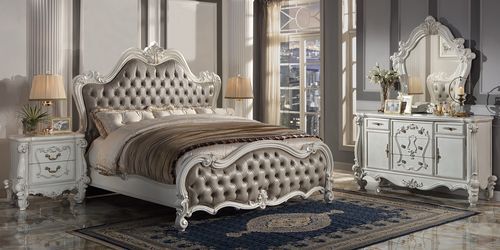 Turn your bedroom into a classy abode with this sophisticated Versailles II bed in a vintage gray PU and bone white finish. The curved wood trim on the headboard and footboard is accentuated with a fluted seashell motif crown. The deep button tufting adds