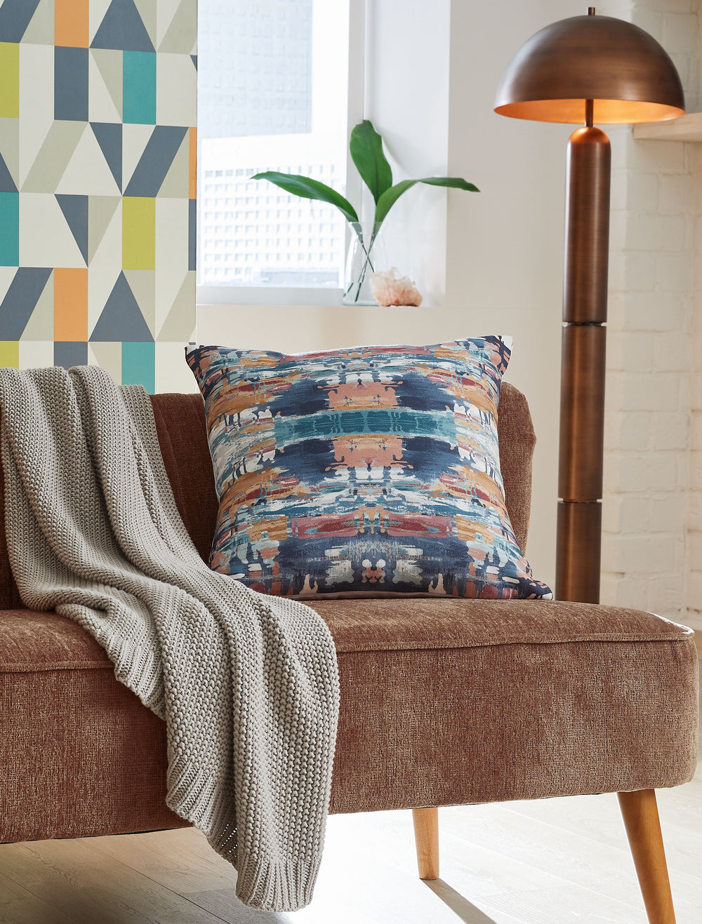 This accent pillow puts a contemporary spin on abstract style. Well-suited for bringing color to neutral spaces, its cool shades of blue are brightened by pops of gold, pink and white. And when youâ€™re ready for a refresh, the cover unzips for easy machi