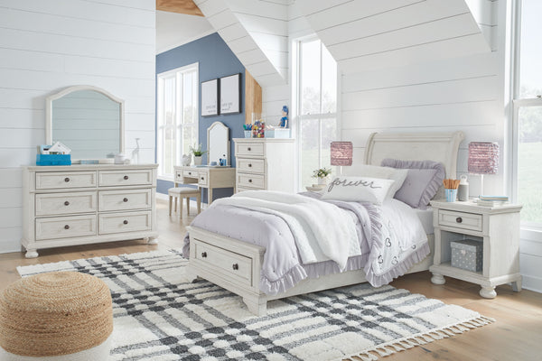 Elegant, timeless furnishings take your bedroom to the next level. Nothing does that better than this sleigh bedroom group. The antiqued white finish with a wonderful grain texture oozes sophistication, while drawers with dark bronze-tone knobs add a soph