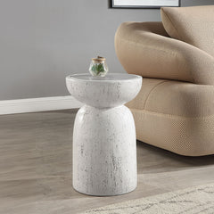 Introduce our Dylana round accent table brings a touch of modern elegance with its fixed table top and faux concrete finish in a nature gray hue. Perfect for contemporary spaces, its minimalist design adds sophistication to any room, making it a stylish a