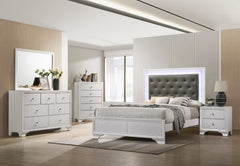 Step into a realm of sophistication and comfort with this stunning bedroom collection. Each piece showcases an exquisite blend of traditional charm and contemporary flair, making a bold statement with its textured surfaces and crisp white finish. The bed,