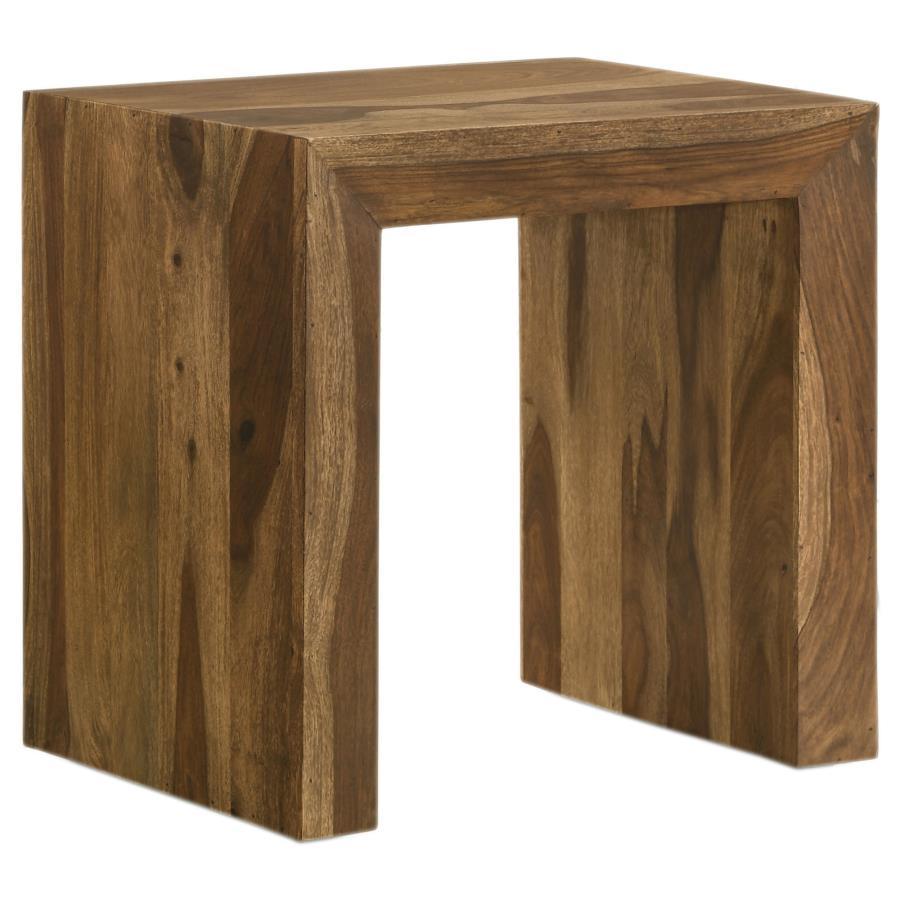 This rectangular end table pairs modern simplicity with rustic charm, featuring a robust U-shaped silhouette and clean lines. Crafted from sustainable solid sheesham wood, its layered auburn finish highlights the natural grain patterns, adding depth and c