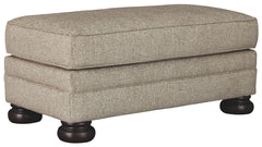 This sumptuously styled ottoman proves that a richly traditional look doesnâ€™t have to break the bank. Choice of a plush chenille upholstery in oatmeal is earthy elegance at its best. Distinctively turned bun feet in a dark finish add to the ottomanâ€™s 