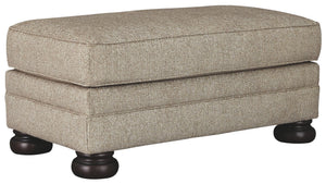 This sumptuously styled ottoman proves that a richly traditional look doesnâ€™t have to break the bank. Choice of a plush chenille upholstery in oatmeal is earthy elegance at its best. Distinctively turned bun feet in a dark finish add to the ottomanâ€™s 
