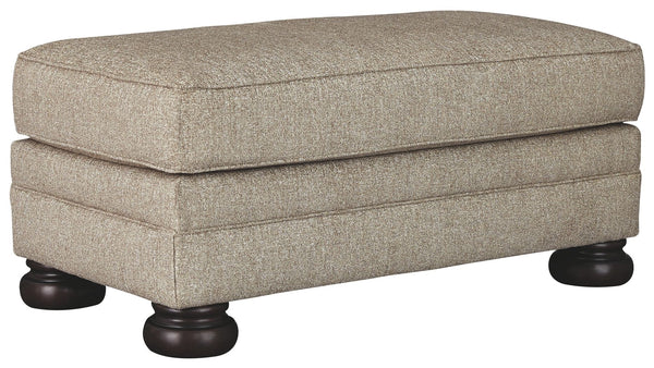 This sumptuously styled ottoman proves that a richly traditional look doesnâ€™t have to break the bank. Choice of a plush chenille upholstery in oatmeal is earthy elegance at its best. Distinctively turned bun feet in a dark finish add to the ottomanâ€™s 