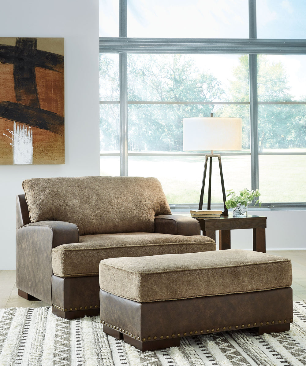 Oversized but not over-the-top, this chair and ottoman are perfect for those who love the look of leather. Two textural tones provide twice the style and comfortâ€”and incorporate an added layer of visual interest. The piece is punctuated by a subtle band