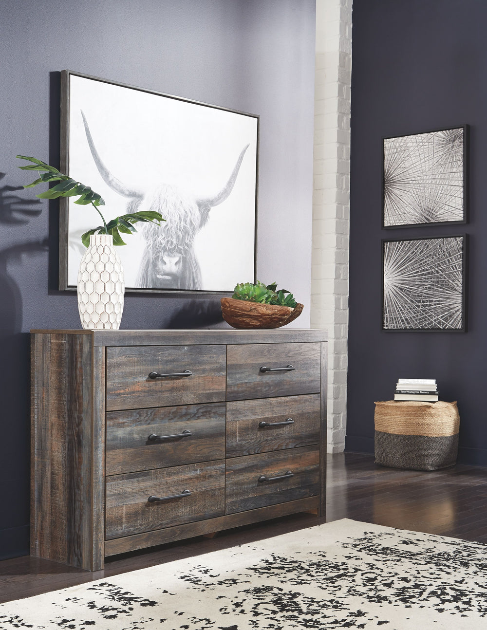 When merged in just the right way, rustic and industrial styles can make one happy marriage. Case in point: this dresser and mirror set. A refined take on barn board beauty, its complex, replicated wood grain showcases hints of burnt orange and teal tones