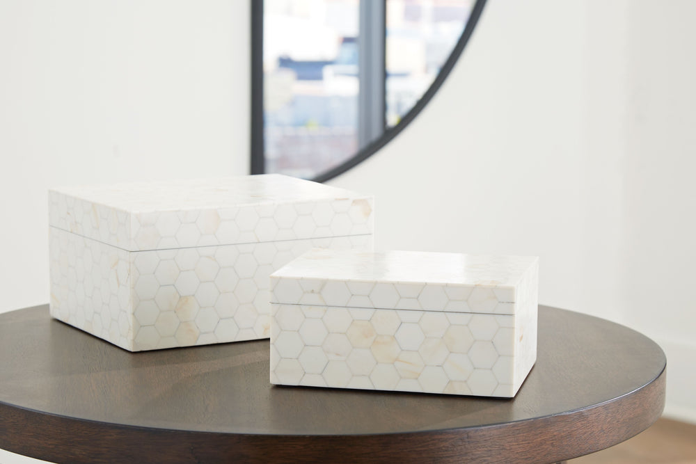 Looking for a casually cool home accent? This set of boxes stacks up beautifully. A hexagonal mosaic design and cream finish bring a laid-back element to your decor. What a stylishly effortless way to refresh your shelves and tabletops.<br><br><b>Addition