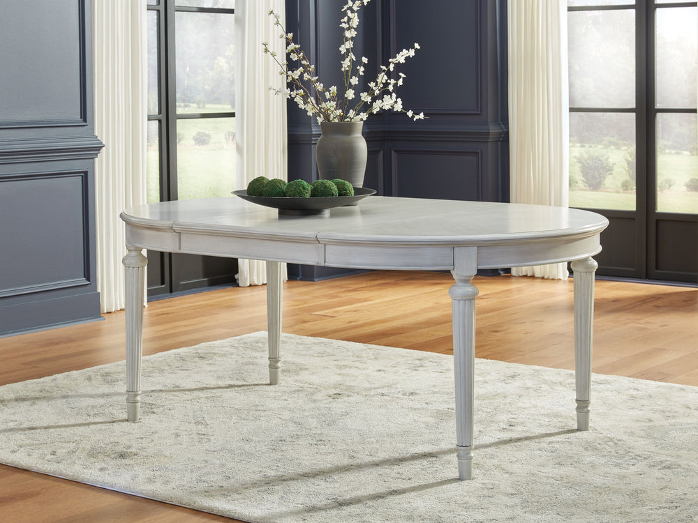 Transform your home into a haven of timeless elegance with this dining extension table. Traditionally styled, its classic antiqued white finish is paired with reeded legs and a tabletop with a butterfly-matched veneer pattern. With the removable center le