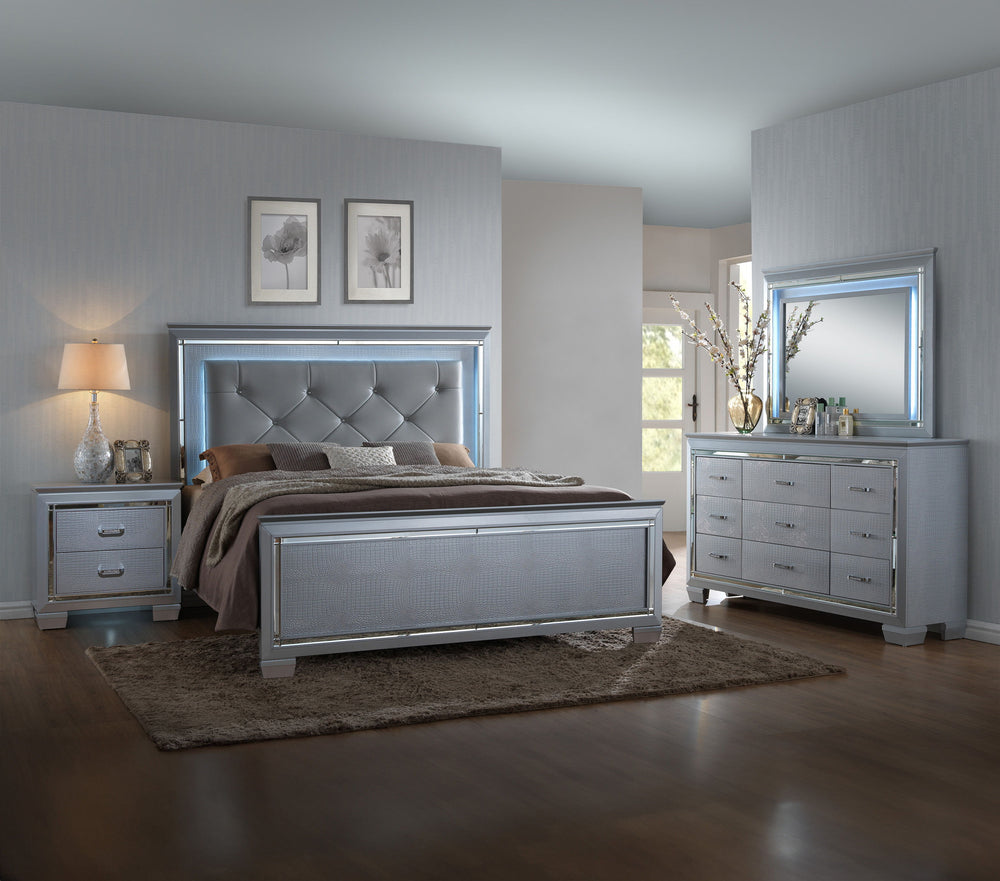 This bedroom collection offers a touch of glamour and luxury to any home. The chic silver finish paired with elegant textured panels creates a sophisticated look that can elevate any bedroom decor. The bed is a statement piece, featuring a stunning tufted