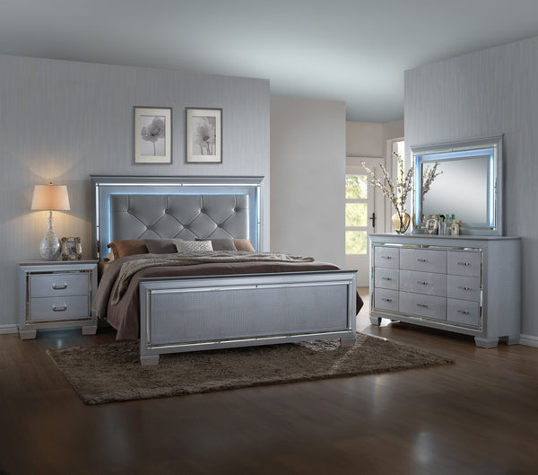 This bedroom collection offers a touch of glamour and luxury to any home. The chic silver finish paired with elegant textured panels creates a sophisticated look that can elevate any bedroom decor. The bed is a statement piece, featuring a stunning tufted