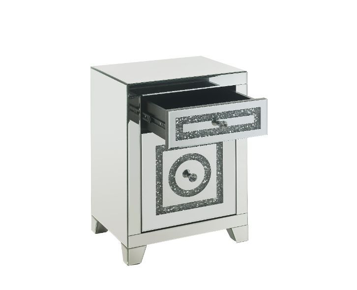 The Noralie Accent Table will give any room a touch of glamour. Mirror and glass materials give it a modern and clear touch while faux diamond inlays add glam style to this piece. Use this unique piece as the perfect accent for any room dÃ©cor. It has a s