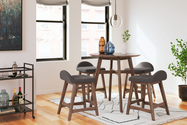 This counter-height dining set is a refreshed take on retro aesthetics. The counter table adds an air of playful simplicity to your dining space and the upholstered bar stool invites the eye with a soft-edged silhouette cushion. This set captures the arch