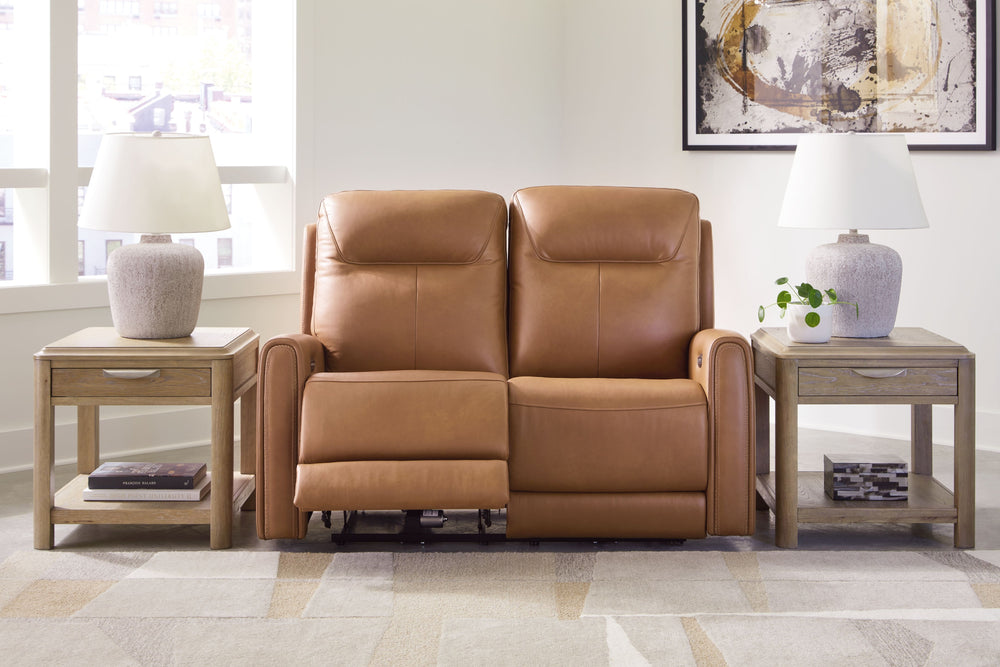 Reserved for him and made for her. This power reclining loveseat delivers all the comfort and style you could ask for. Inspired by sports car interiors, the expertly matched leather and faux leather upholstery features jumbo stitching for even more appeal