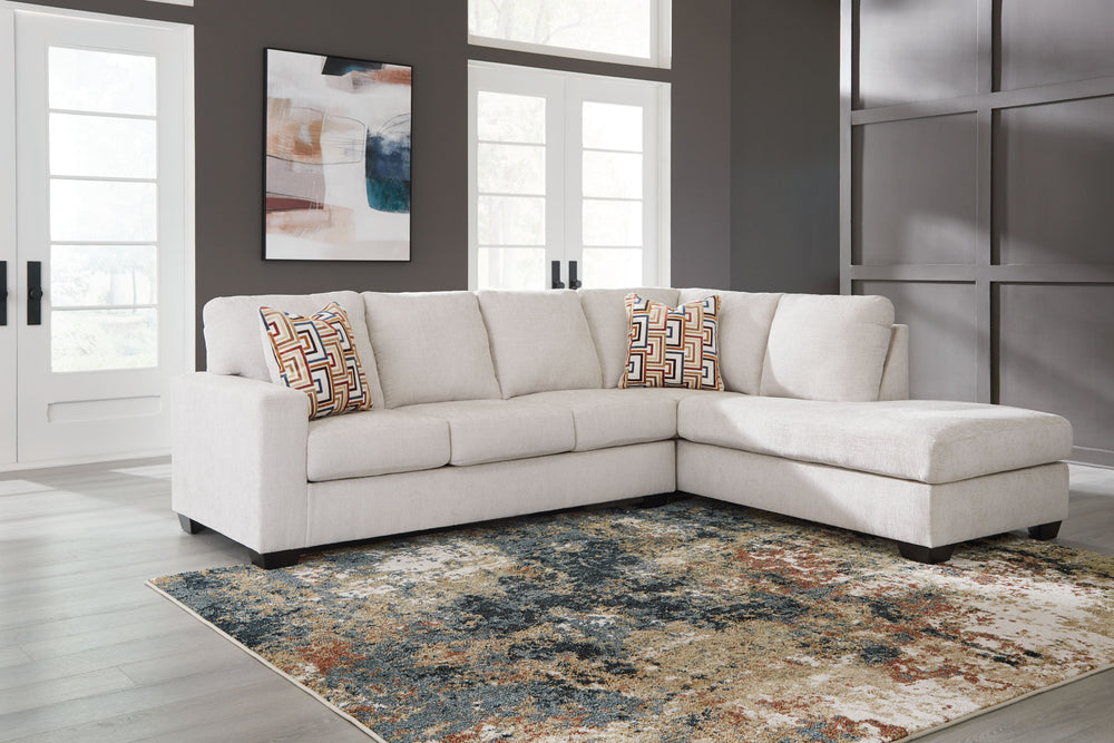 Looking to make a simply chic statement with color? Liven up your living room with this sectional with chaise. Its trend-right light neutral upholstery is a perfect blank canvas for adding pops of color. Bold and eclectic accent pillows complete the look.