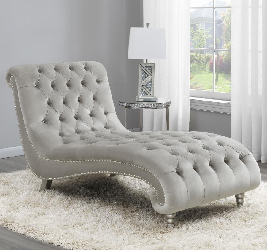 Grace your living area or master suite with this exceptional chaise lounge. Upholstered in luxurious grey velvet, this piece creates an eye-catching display. All-over button tufting is enhanced with metallic buttons. Nail head trim adorns the frame for st