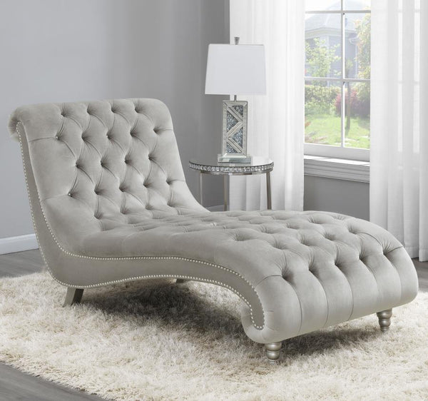 this piece creates an eye-catching display. All-over button tufting is enhanced with metallic buttons. Nail head trim adorns the frame for st