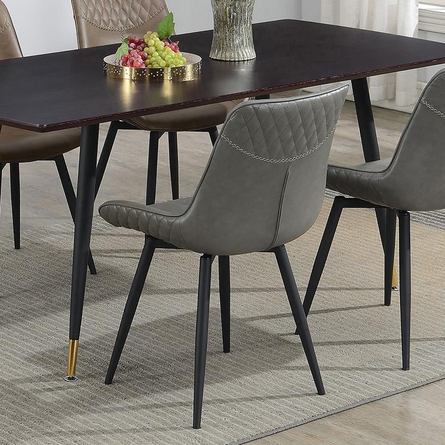 Bringing together mid-century modern elegance and contemporary comfort, this swivel dining chair is a stylish statement piece. Wrapped in soft grey fabric upholstery, its scooped seat and plush padding provide exceptional comfort. The quilted detailing on