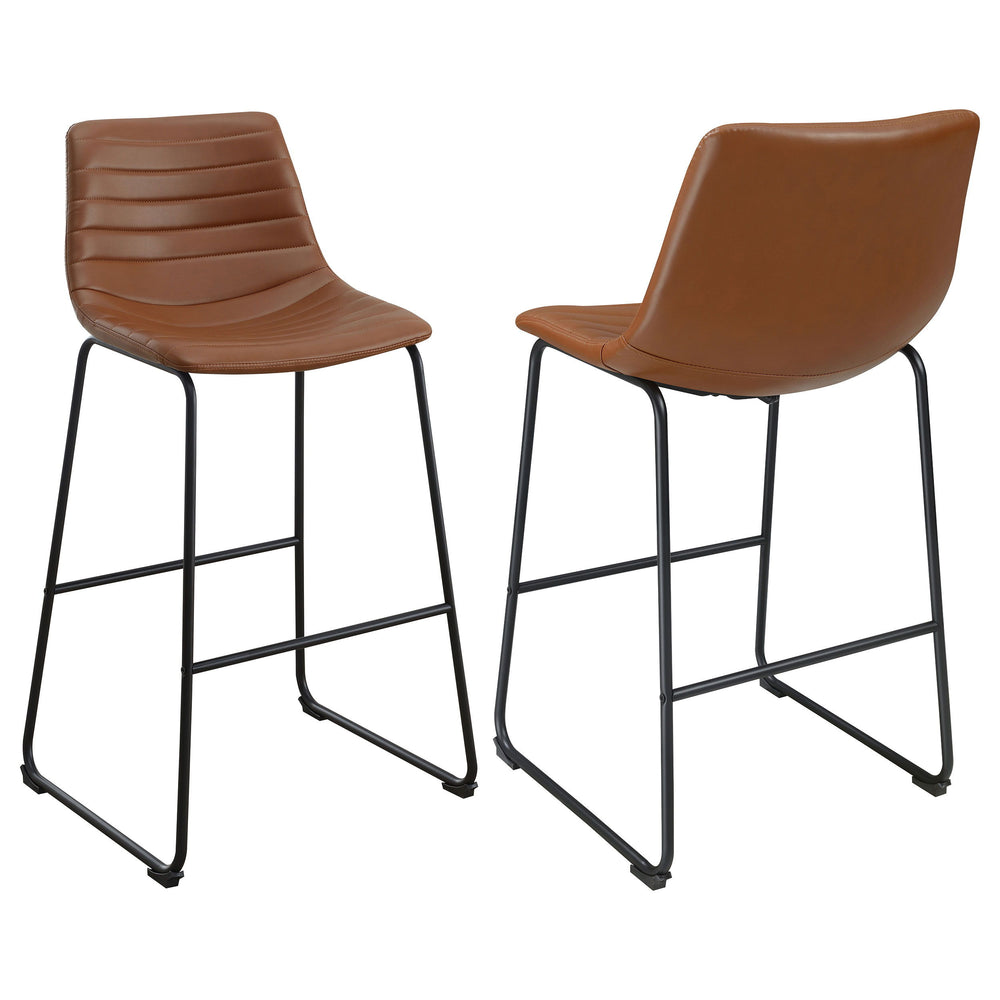 Upgrade kitchen or lounge seating with the refined look of a set of two contemporary barstools. Each boasts faux leather upholstery over a bucket style seat. Channel tufting adds a sense of depth and movement while highlighting intriguing color. The stool