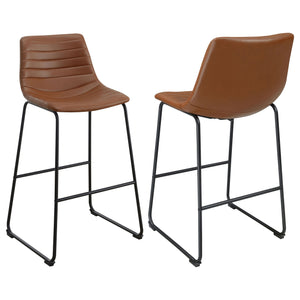 Upgrade kitchen or lounge seating with the refined look of a set of two contemporary barstools. Each boasts faux leather upholstery over a bucket style seat. Channel tufting adds a sense of depth and movement while highlighting intriguing color. The stool