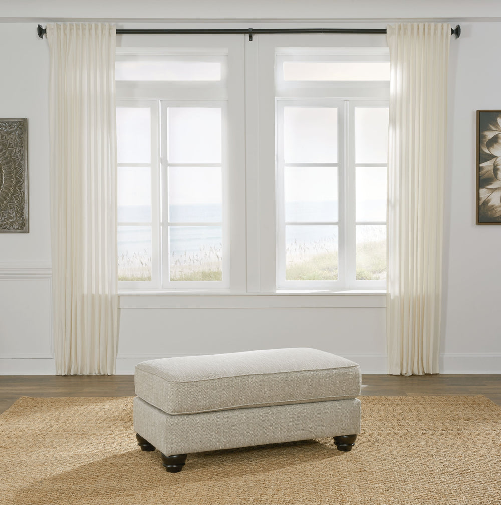 Blending comfort and style, this ottoman cradles your tired feet at the end of a long day. The distinctive look of heavily textured fabric in a light, neutral hue is enhanced by lighter flax peeking through. Whether paired with another piece or used on it