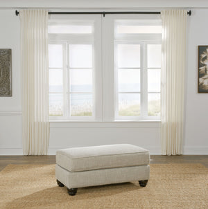  this ottoman cradles your tired feet at the end of a long day. The distinctive look of heavily textured fabric in a light