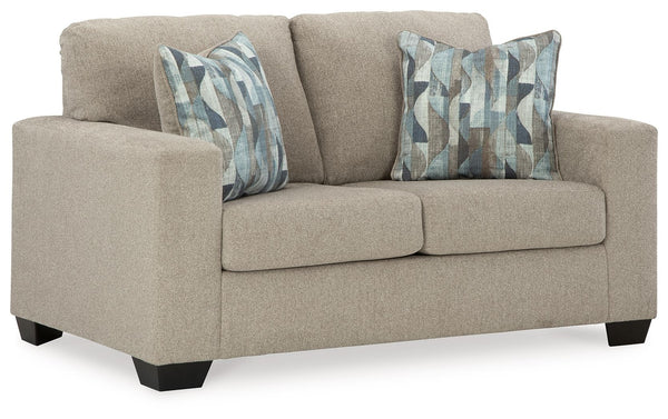 Youâ€™re in for a neat treat with this loveseat. Its comfy seats are covered in soft, textural upholstery, and the wide track arms are eager to support your quest for total relaxation. Distressed abstract toss pillows bring a fresh breath of contemporary 