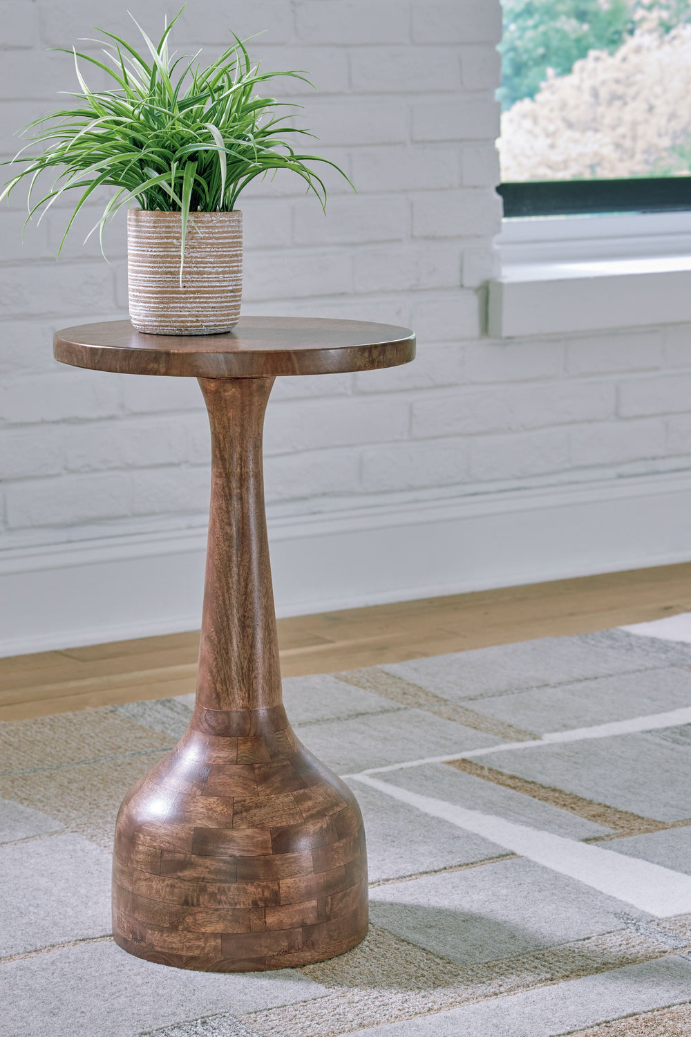 The perfect pedestal for a plant or decorative accents, this accent table highlights the simple refinement of wood. Its slim-turned design slides expertly between chairs or next to a wall, providing a chic surface for drinks and other essentials. Itâ€™s a