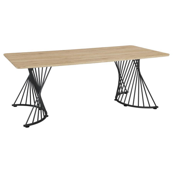 Make a statement in your dining room with this sculptural rectangular table, combining rustic charm and industrial flair. Featuring a natural oak grain top with a durable, easy-care laminate veneer, it sits on bold dual pedestal bases crafted from twisted