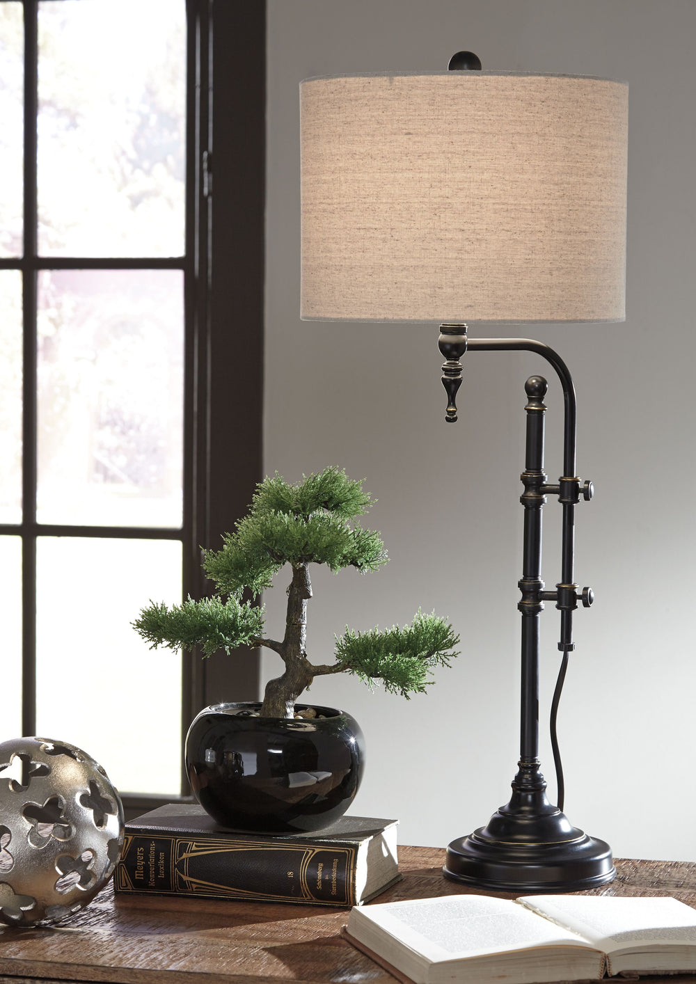 Up your style with this table lamp that takes a charmingly unique stance on lighting. Simply turn the pair of knobs on the sculptural metal base to adjust the light to the perfect height. How delightful.<br><br><b>Additional Dimensions</b><br><ul><li>Adju