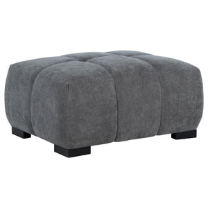 Add versatility and comfort to your seating area with this plush, mid-century inspired ottoman. Its soft, neutral upholstery and subtle grid tufting bring depth and texture to your dÃ©cor, while a sturdy frame ensures lasting durability. Ideal as a footre