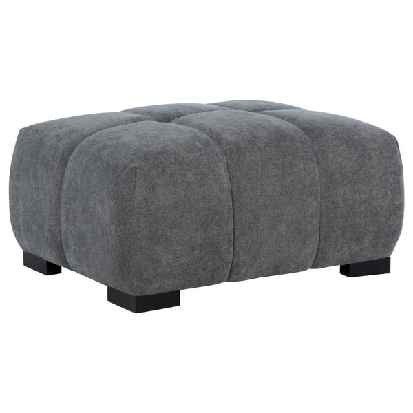 Add versatility and comfort to your seating area with this plush, mid-century inspired ottoman. Its soft, neutral upholstery and subtle grid tufting bring depth and texture to your dÃ©cor, while a sturdy frame ensures lasting durability. Ideal as a footre