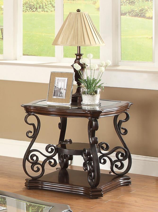 This elegant end table brings a blend of classic style and practicality to any living space. The clear tempered glass top offers a durable and polished surface, complemented by ornate scrollwork on the dark bronze powder-coated metal legs. The dark merlot