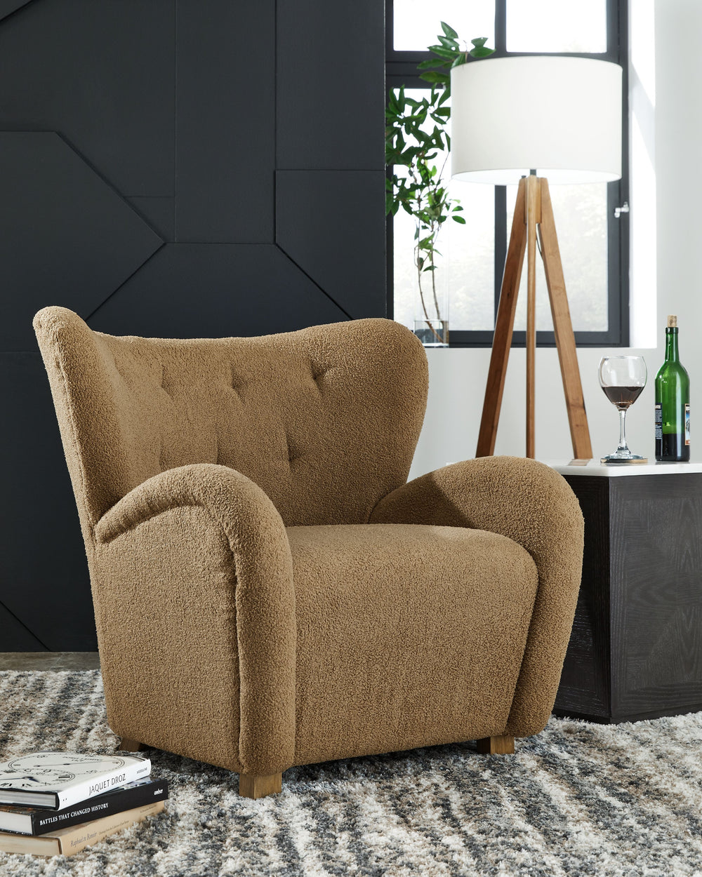 High style meets relaxation in this accent chair. Cozy faux shearling fabric keeps the look contemporary without compromising on comfort. A tufted wingback design and dramatic slope arms add high-fashion flair. It-'s the perfect place to curl up and enjoy
