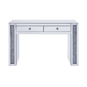The Noralie Vanity Desk will give any room a touch of glamour. This contemporary desk is fully mirrored with a stunning mirror top and a faux diamond inlay on each leg of its sled base. Use this unique vanity desk for make-up application, jewelry, or as a