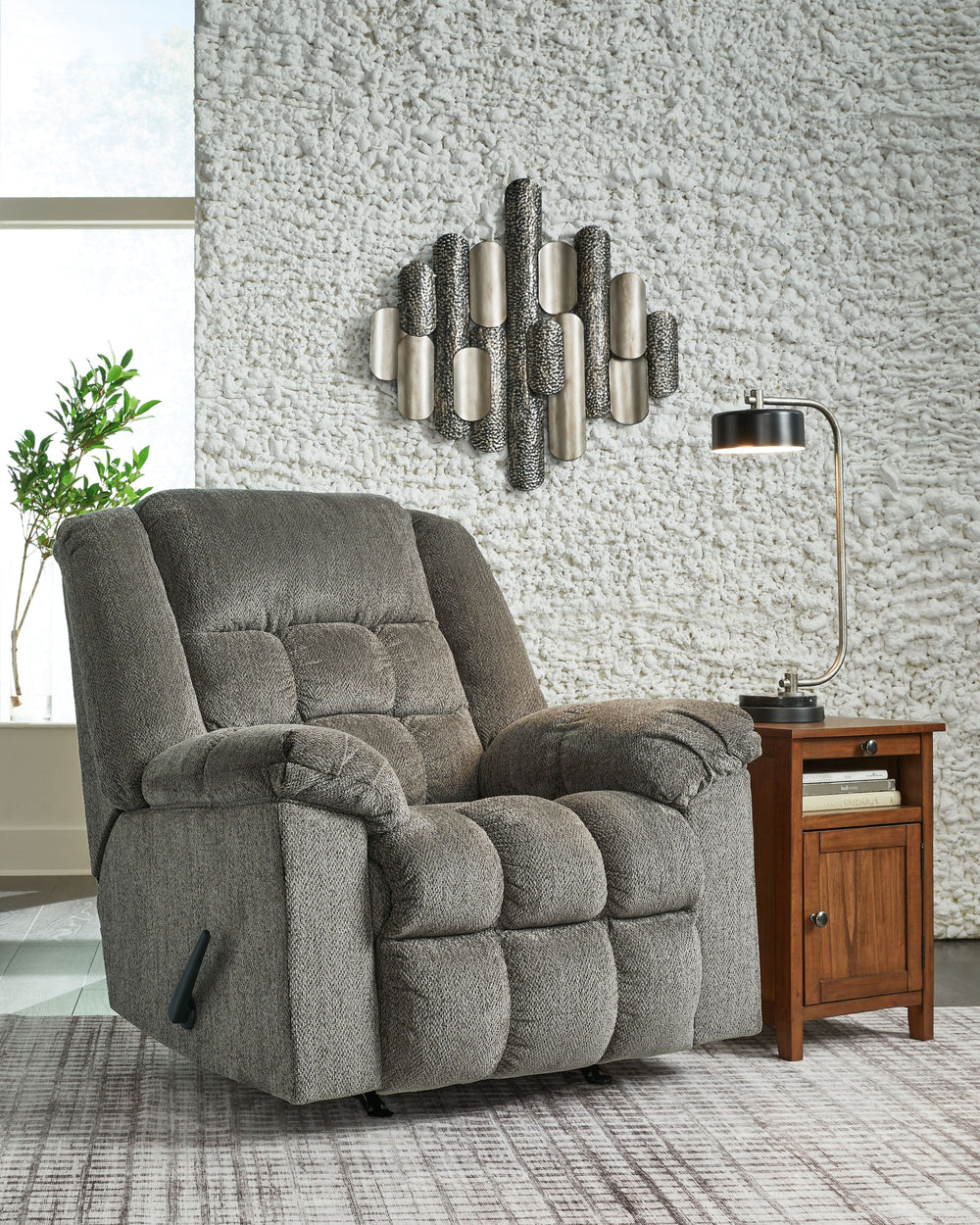 Prioritize comfort while still making a versatile style statement. Complementing a variety of color schemes, this rocker recliner-'s supremely plush seating lines you up for hours of leisure. Its one-pull reclining motion places you in optimal TV watching